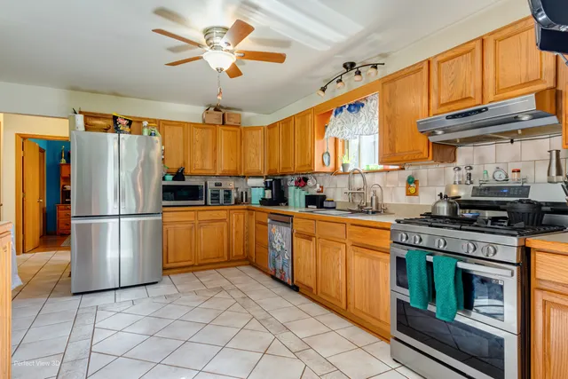 a kitchen with stainless steel appliances granite countertop a stove cabinets and a refrigerator
