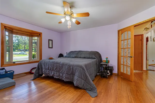 a bedroom with a bed and a chandelier
