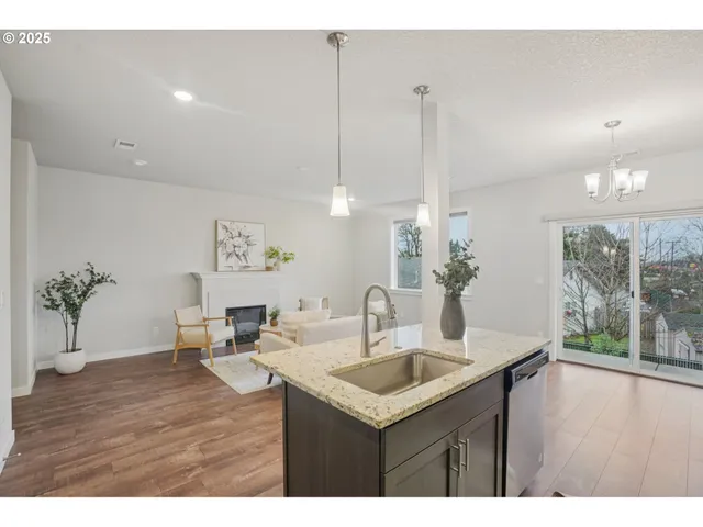 a kitchen with a sink cabinets and wooden floor