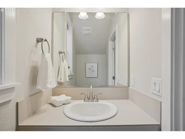 a bathroom with a sink vanity and a mirror
