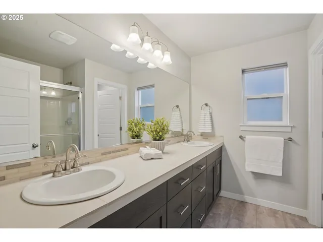 a bathroom with a sink double vanity and a mirror