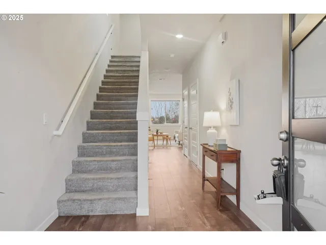 a view of entryway and hall with wooden floor
