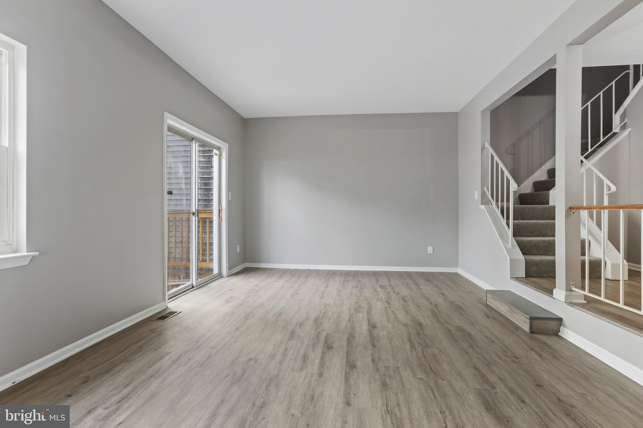 8617 Castlemill Circle Nottingham, MD 21236 - Photo 12 of 25 an empty room with wooden floor and windows