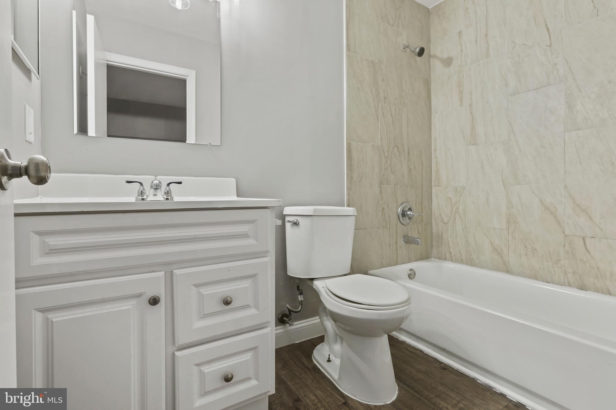 8617 Castlemill Circle Nottingham, MD 21236 - Photo 16 of 25 a bathroom with a sink toilet and shower