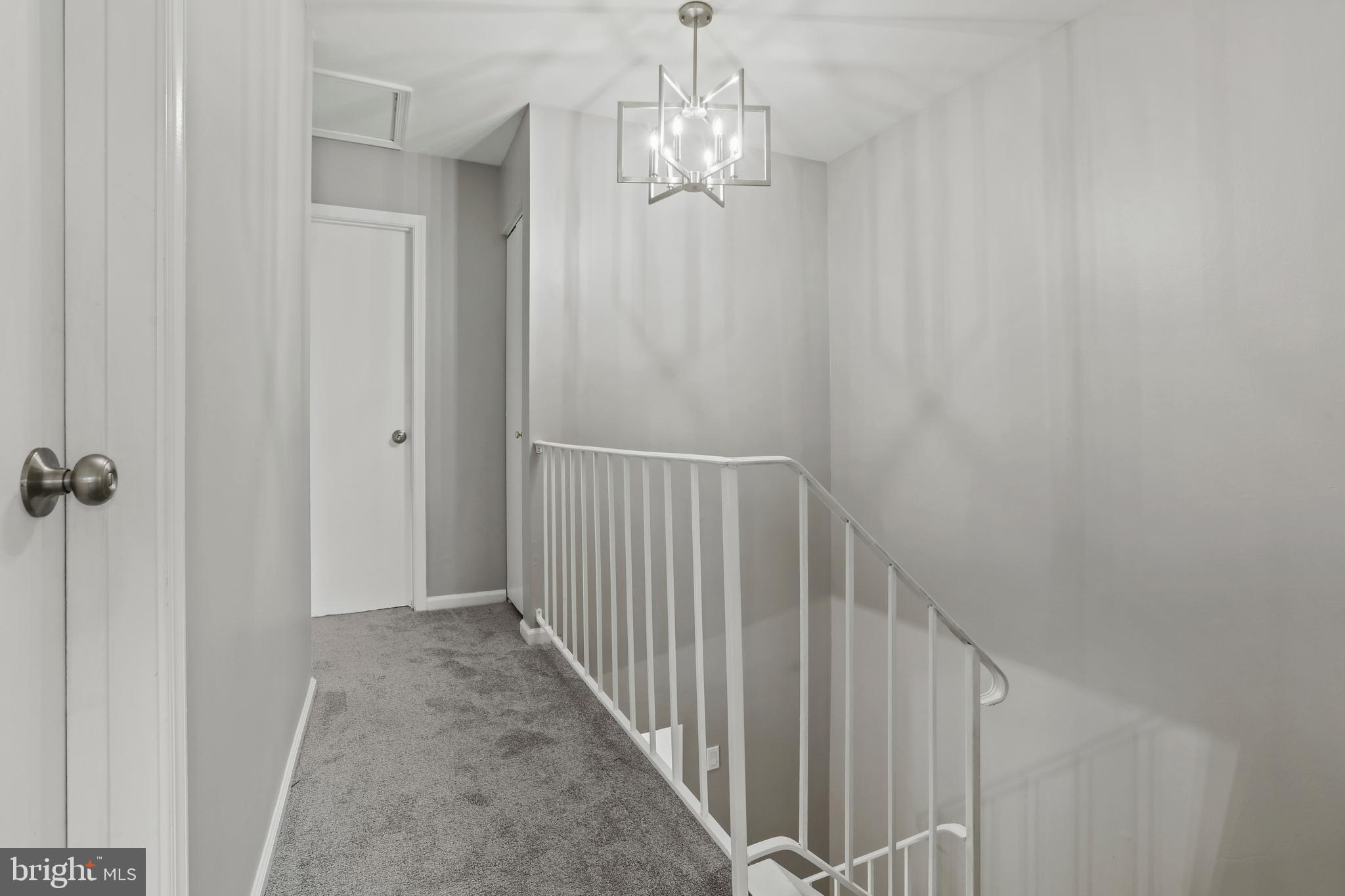 8617 Castlemill Circle Nottingham, MD 21236 - Photo 17 of 25 a view of a hallway with a chandelier