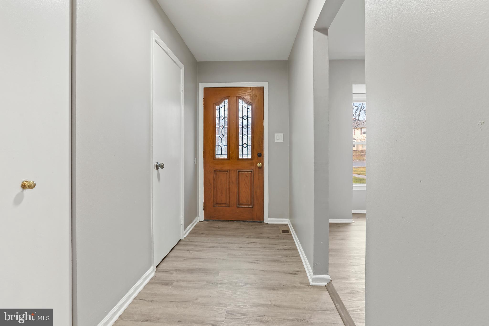 8617 Castlemill Circle Nottingham, MD 21236 - Photo 2 of 25 a view of a hallway with wooden floor