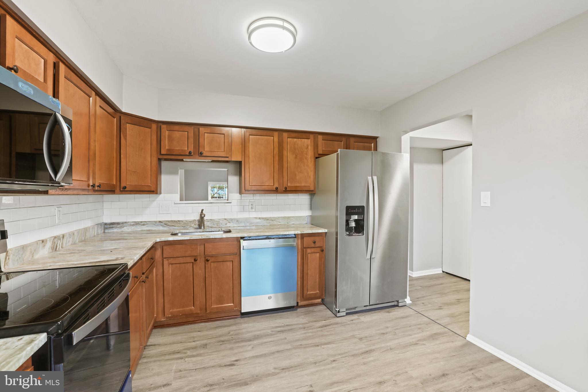 8617 Castlemill Circle Nottingham, MD 21236 - Photo 5 of 25 a kitchen with stainless steel appliances granite countertop a sink stove and refrigerator