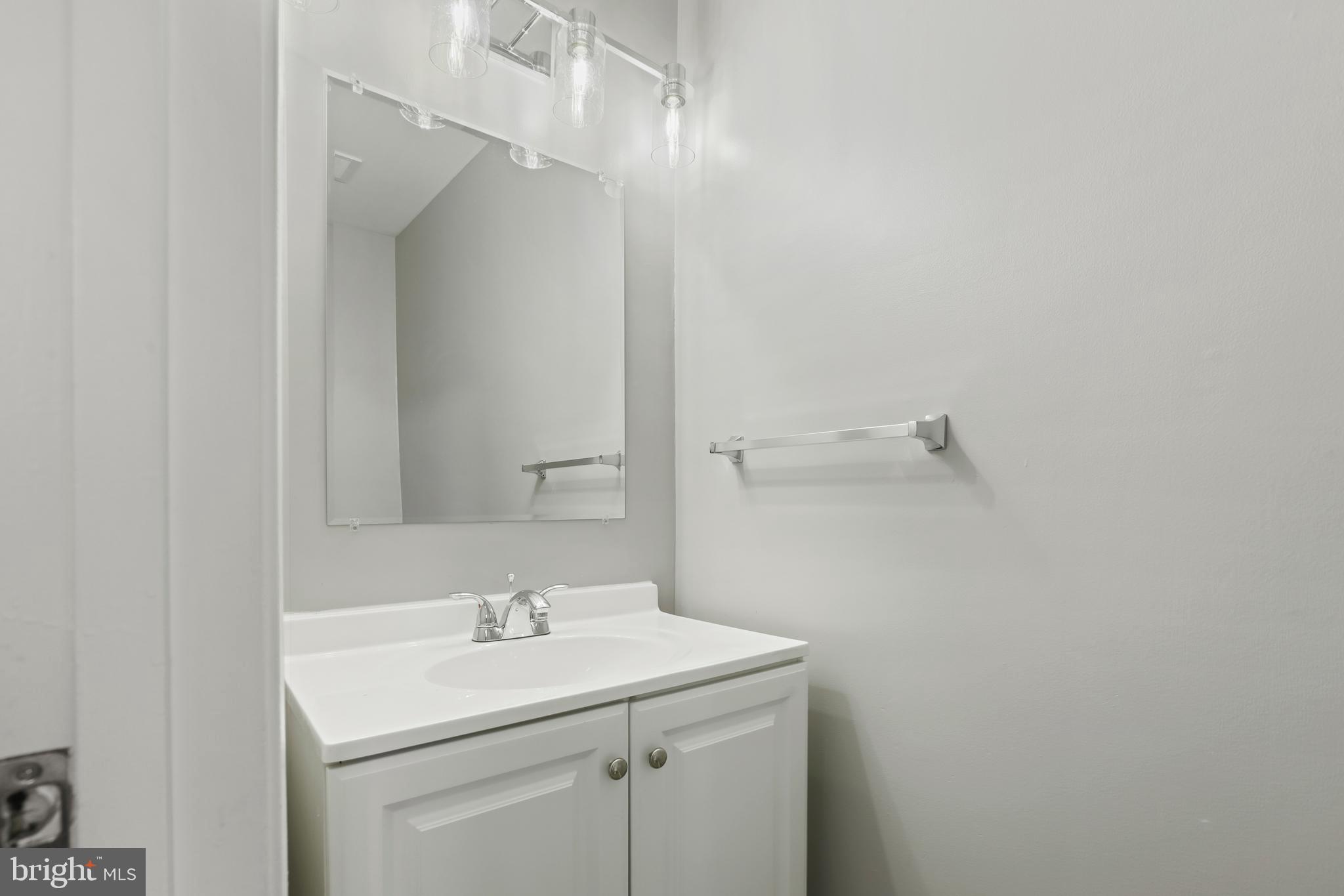 8617 Castlemill Circle Nottingham, MD 21236 - Photo 7 of 25 a bathroom with a sink and mirror