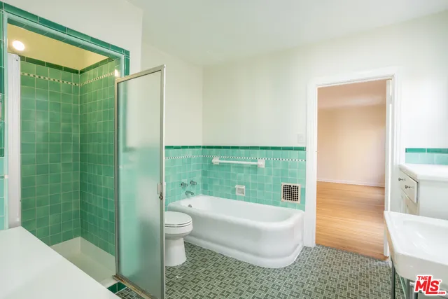 a bathroom with a shower a bathtub and a sink