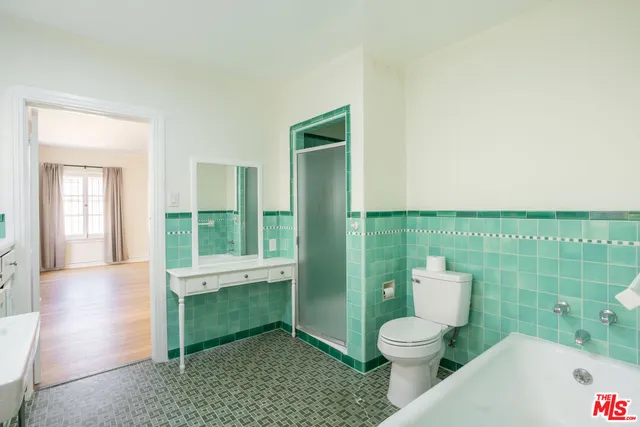 a bathroom with a toilet a sink and bathtub