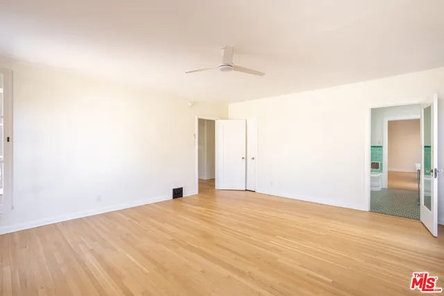 a view of empty room with wooden floor
