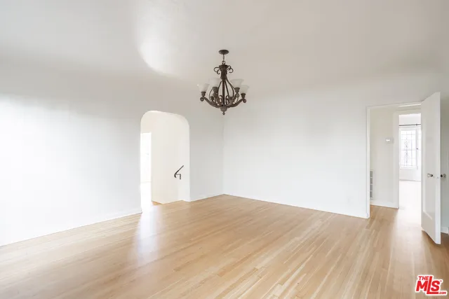 a view of a room with wooden floor and ceiling fan