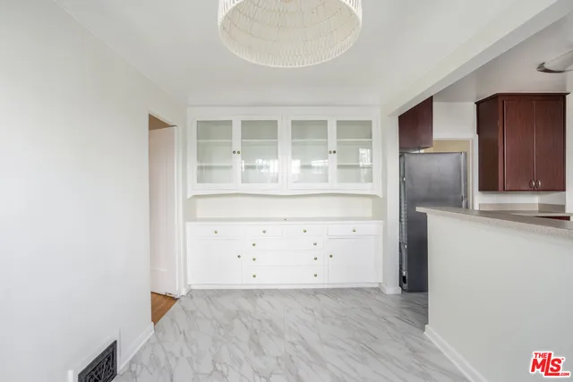 an empty room with cabinet and wooden floor