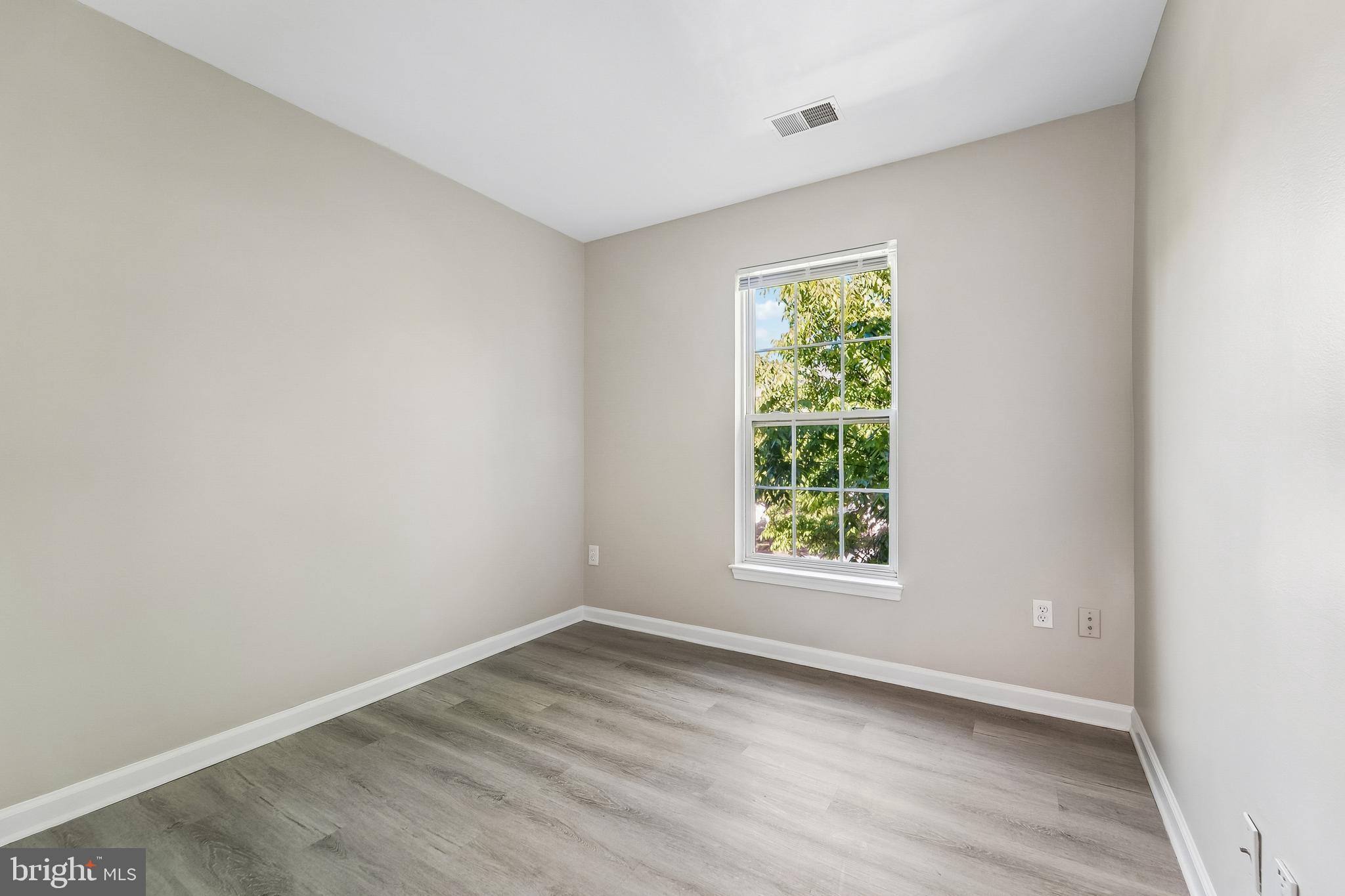1461 Pangbourne Way Hanover, MD 21076 - Photo 30 of 51 wooden floor in an empty room with a window