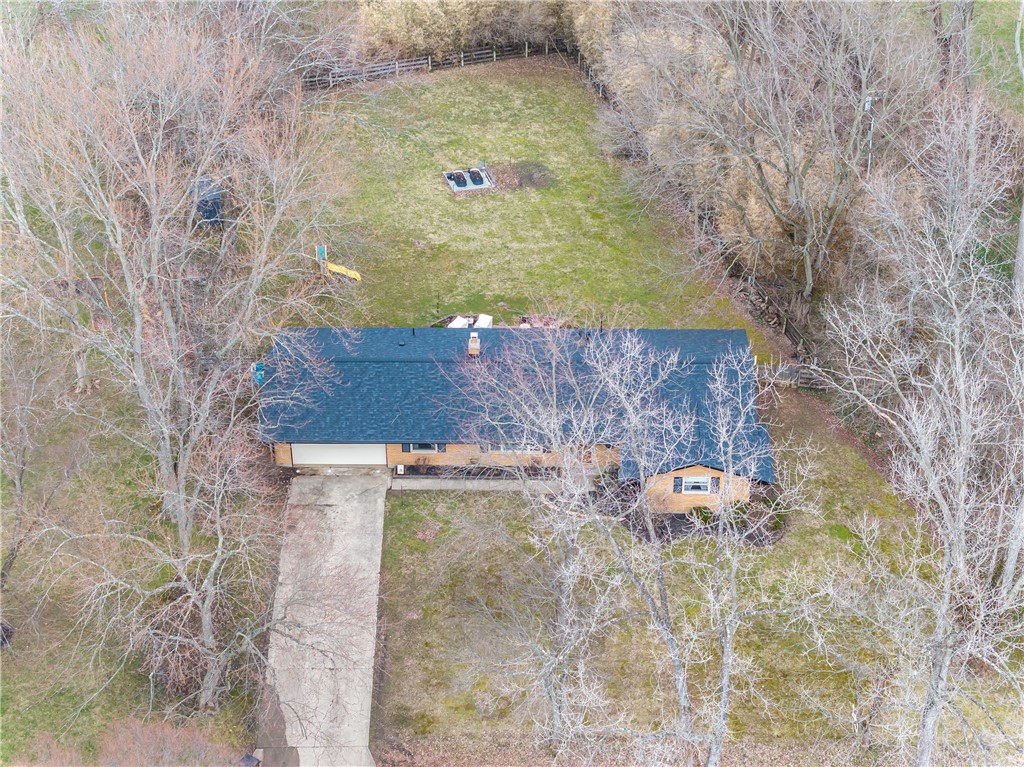 4102 Ridgetop Drive Bellbrook, OH 45305 - Photo 32 of 33 An aerial view showcases the home with a lush yard and mature trees, offering privacy and natural beauty.