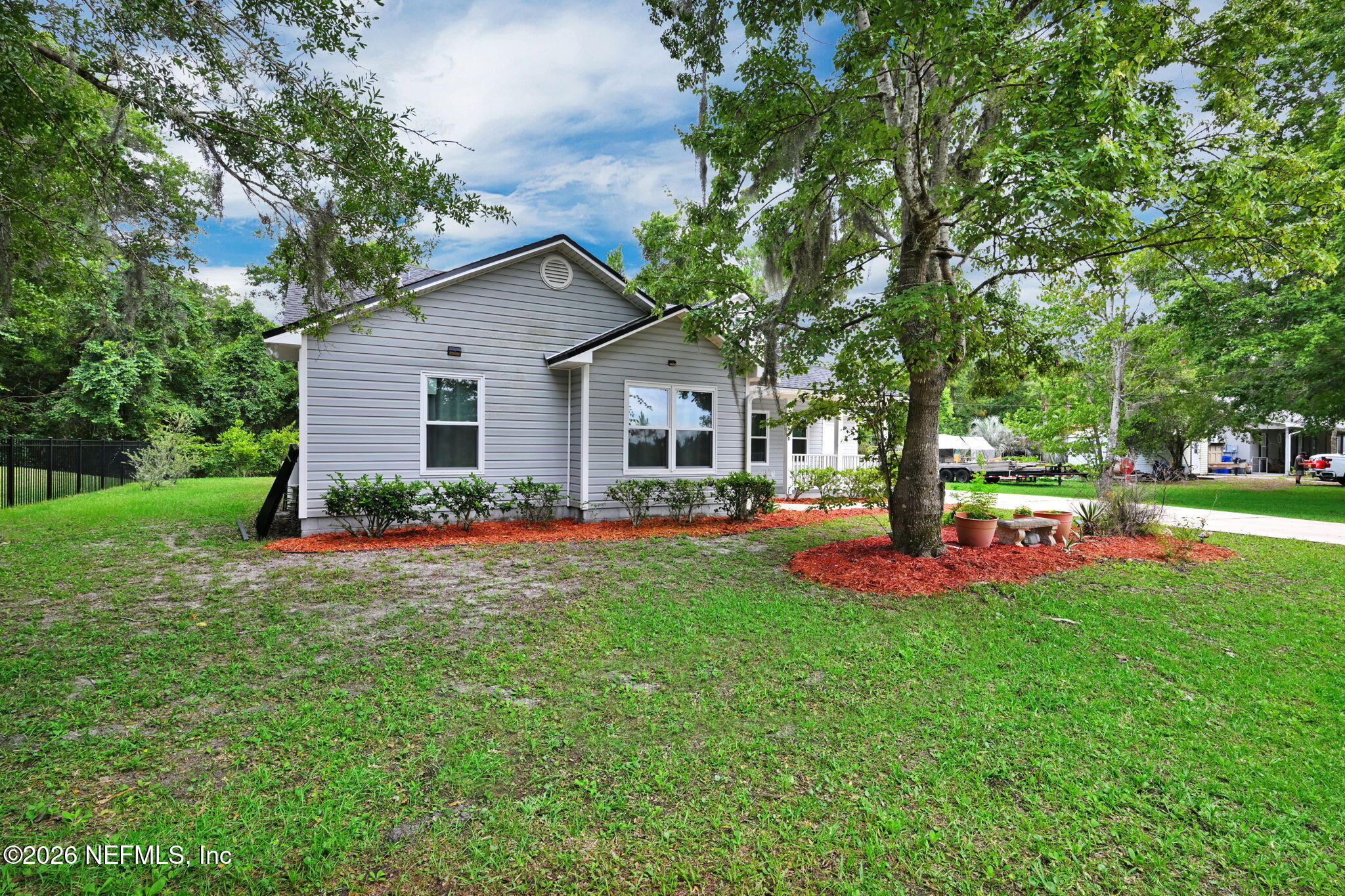 1110 Woodlawn Road, Unit D St. Augustine, FL 32084 - Photo 3 of 40 a front view of a house with porch and garden