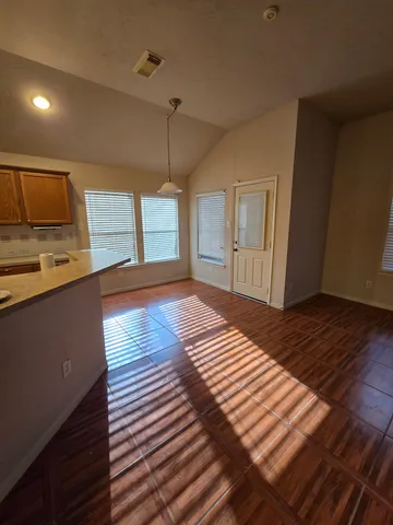 a bedroom with a bed and a view of kitchen