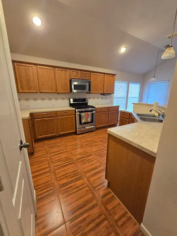a kitchen with stainless steel appliances cabinets and a counter top space
