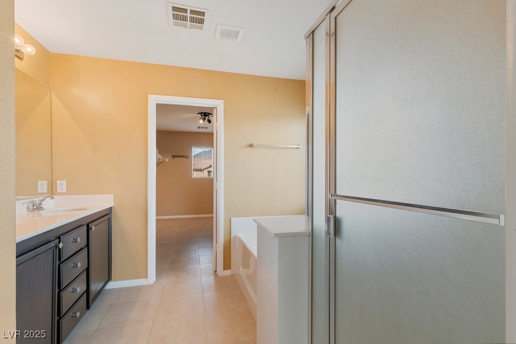 5033 Ropers Rock Court Las Vegas, NV 89131 - Photo 13 of 40 Bathroom with vanity, a bath, light tile patterned floors, and a stall shower