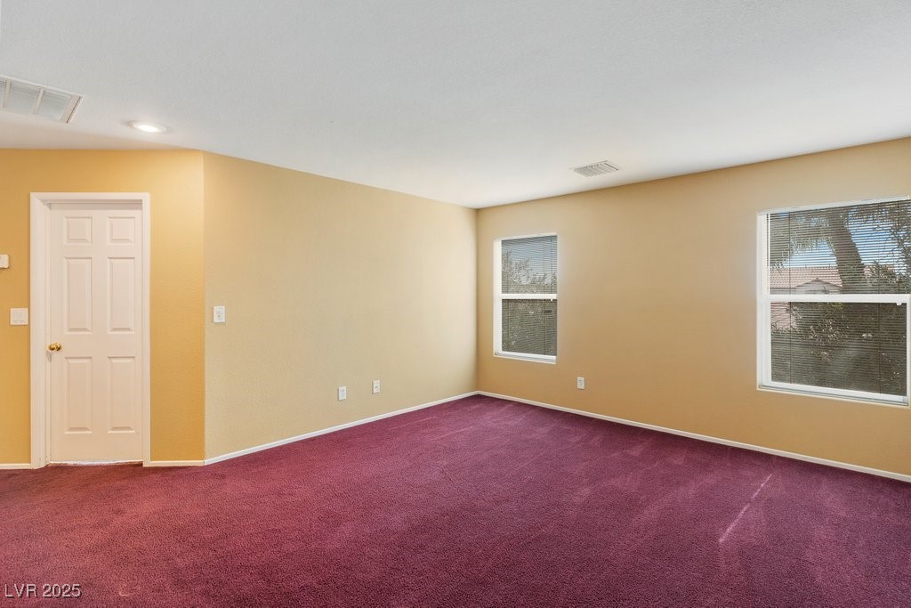 5033 Ropers Rock Court Las Vegas, NV 89131 - Photo 18 of 40 Carpeted spare room featuring plenty of natural light