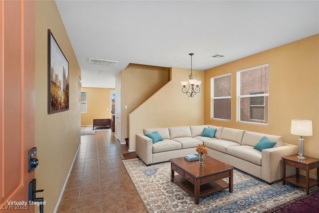 5033 Ropers Rock Court Las Vegas, NV 89131 - Photo 2 of 40 Living area with tile patterned floors and a chandelier
