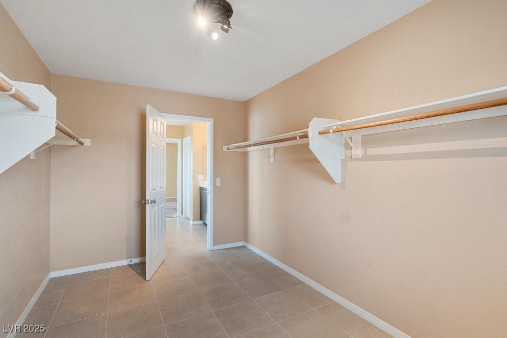 5033 Ropers Rock Court Las Vegas, NV 89131 - Photo 24 of 40 Spacious closet featuring light tile patterned floors