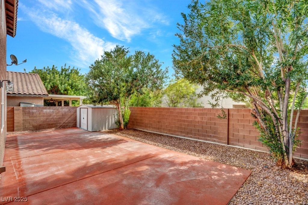 5033 Ropers Rock Court Las Vegas, NV 89131 - Photo 33 of 40 Fenced backyard featuring a storage shed and a patio area