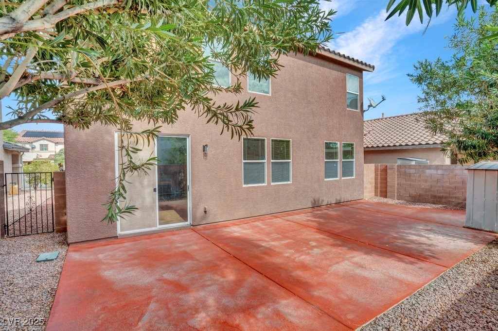 5033 Ropers Rock Court Las Vegas, NV 89131 - Photo 34 of 40 Back of house featuring a patio, stucco siding, and a tile roof