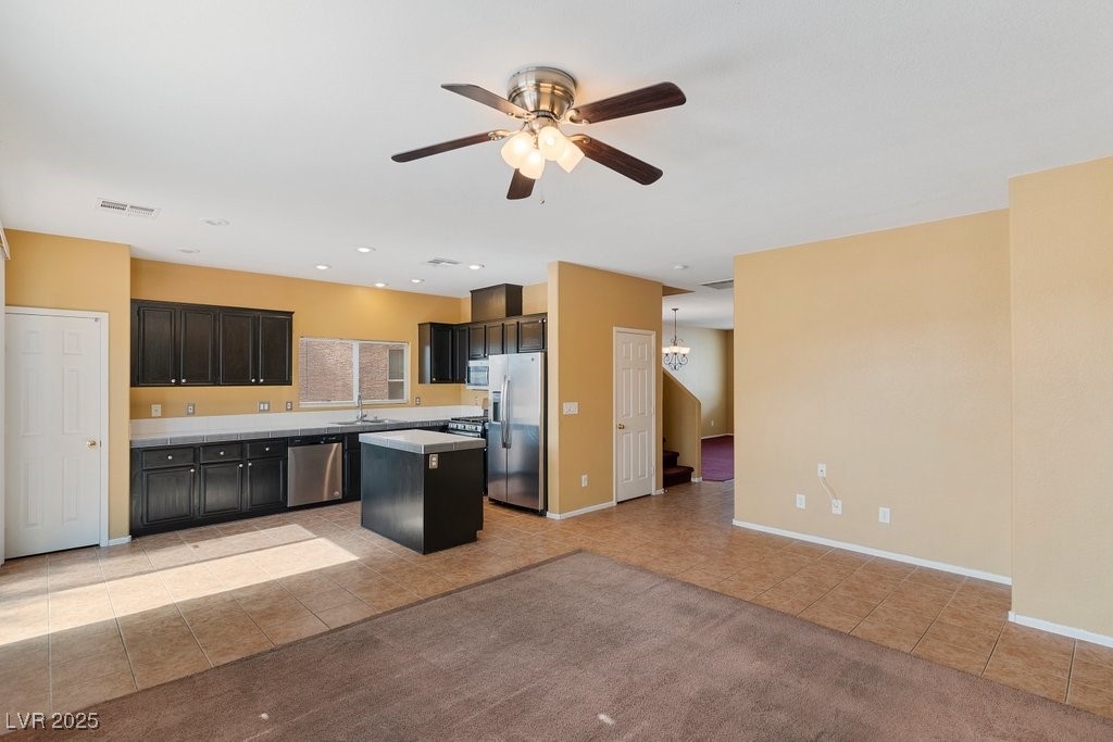 5033 Ropers Rock Court Las Vegas, NV 89131 - Photo 37 of 40 Kitchen featuring open floor plan, light tile patterned floors, a kitchen island, appliances with stainless steel finishes, and light countertops