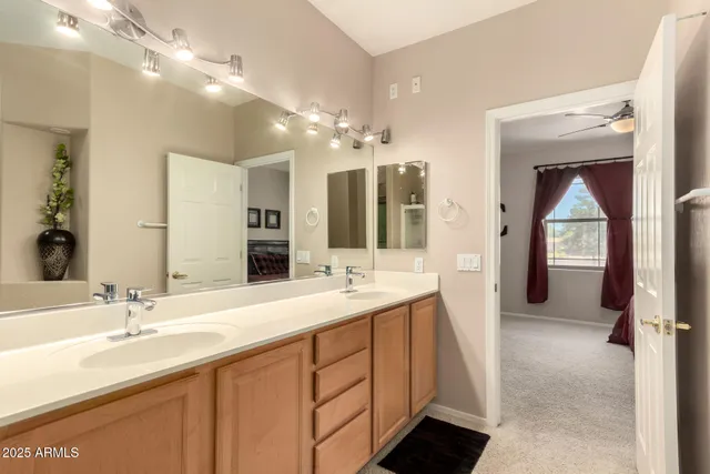 a bathroom with a double vanity sink and a mirror