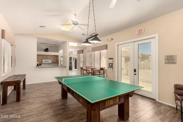 a room with pool table and windows