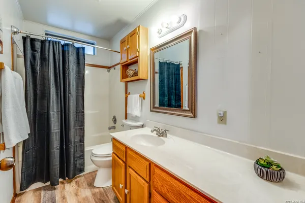 a bathroom with a sink mirror and a shower