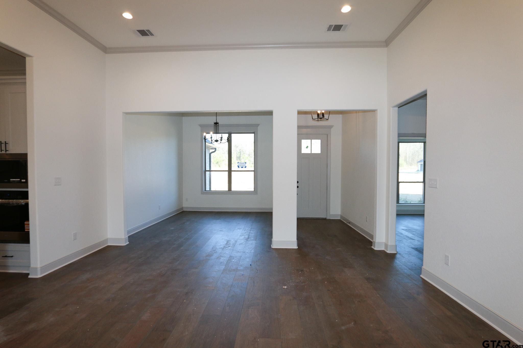16527 Cooper Way Flint, TX 75762 - Photo 11 of 33 an empty room with wooden floor and windows