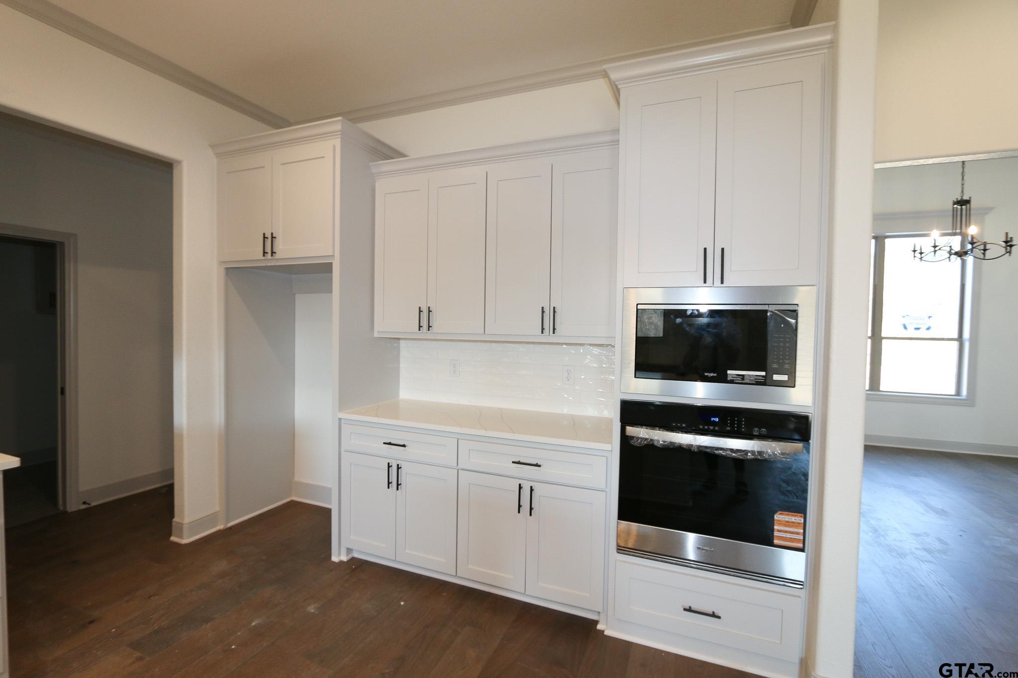 16527 Cooper Way Flint, TX 75762 - Photo 16 of 33 a kitchen with white cabinets and white appliances