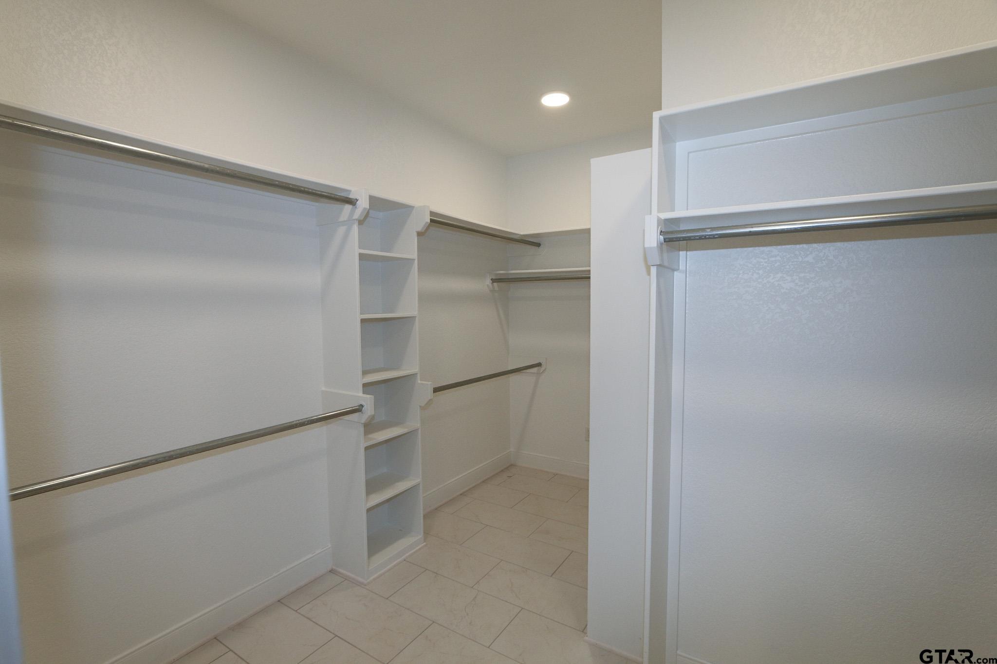 16527 Cooper Way Flint, TX 75762 - Photo 24 of 33 a view of walk in closet with empty racks