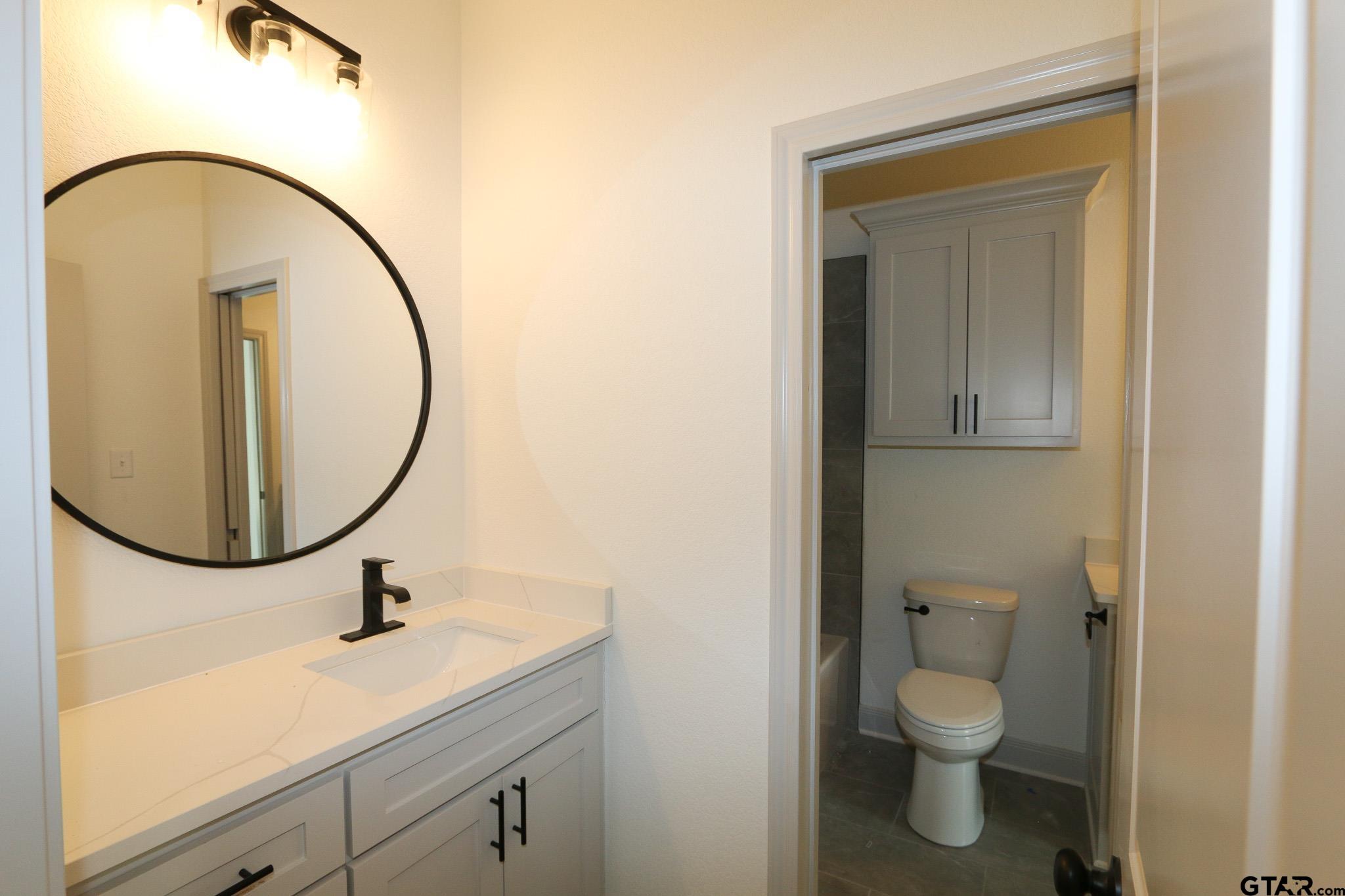 16527 Cooper Way Flint, TX 75762 - Photo 27 of 33 a bathroom with a sink and a mirror