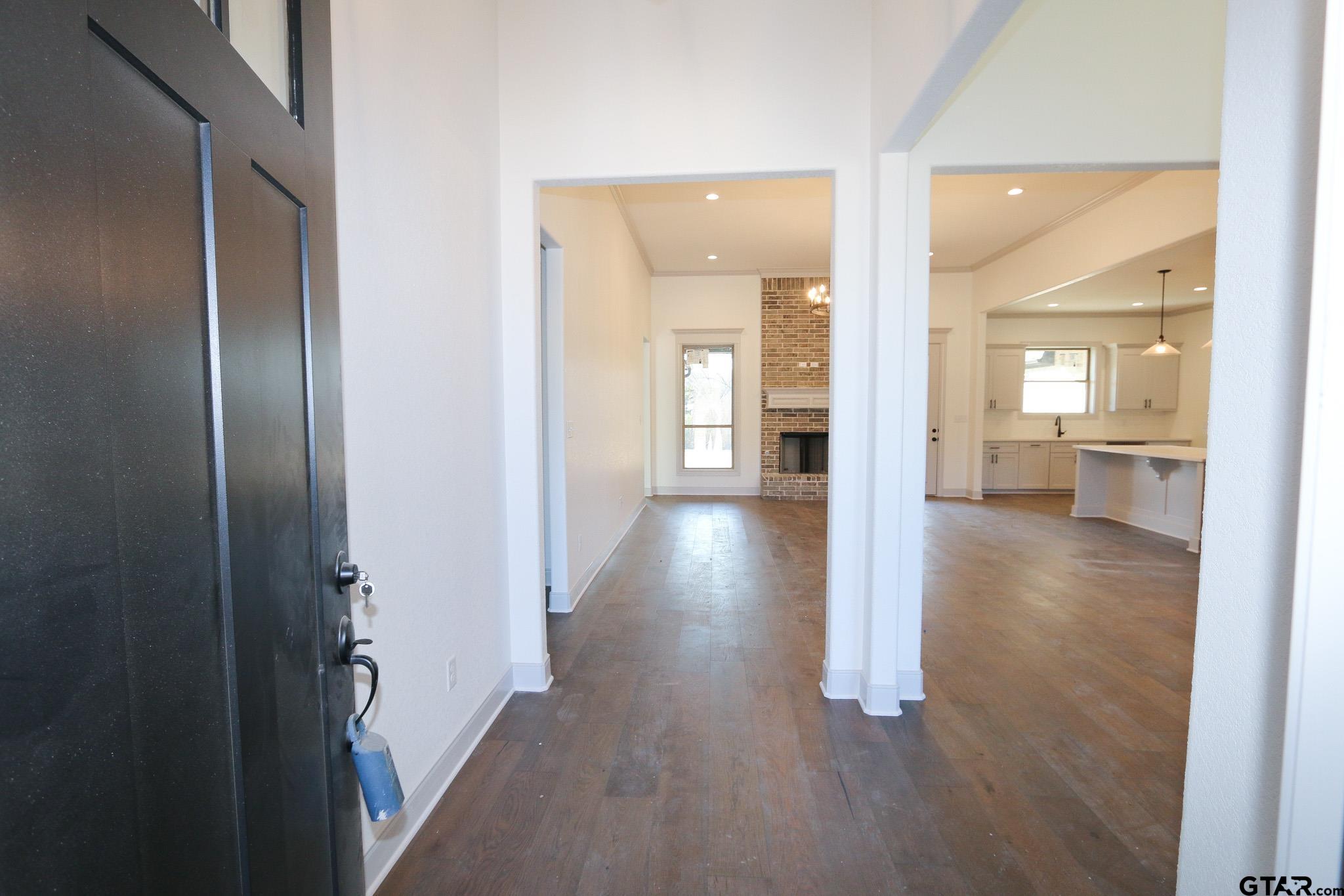 16527 Cooper Way Flint, TX 75762 - Photo 7 of 33 a view of a hallway with wooden floor windows and a kitchen