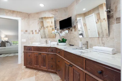 a spacious bathroom with double sink and a mirror