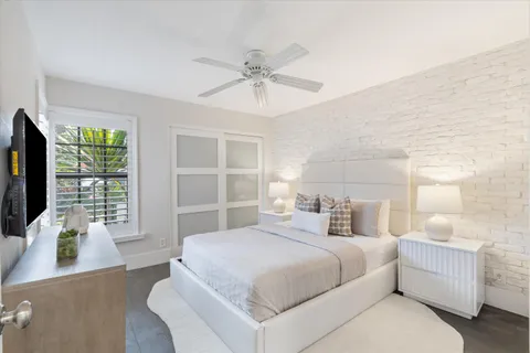 a bedroom with a large bed and a flat screen tv