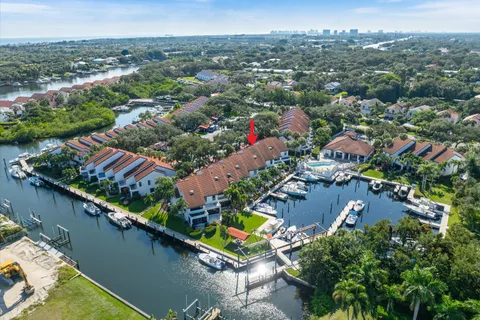 an aerial view of residential houses with outdoor space and river view