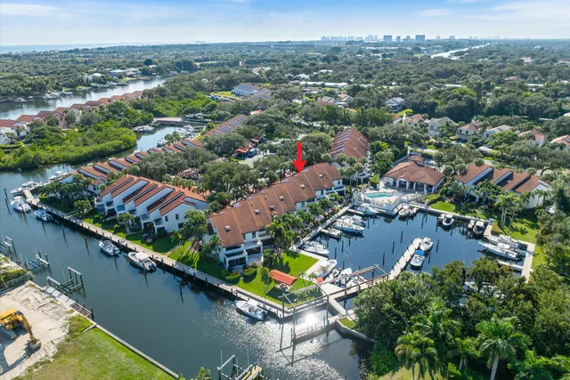 an aerial view of residential houses with outdoor space and river view