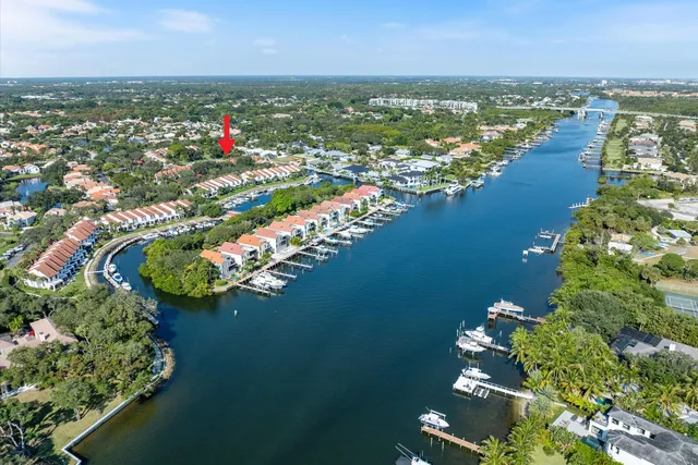 an aerial view of lake and residential houses with outdoor space