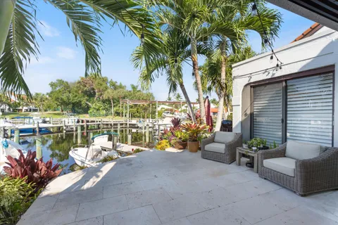a view of a balcony with chairs and a potted plant