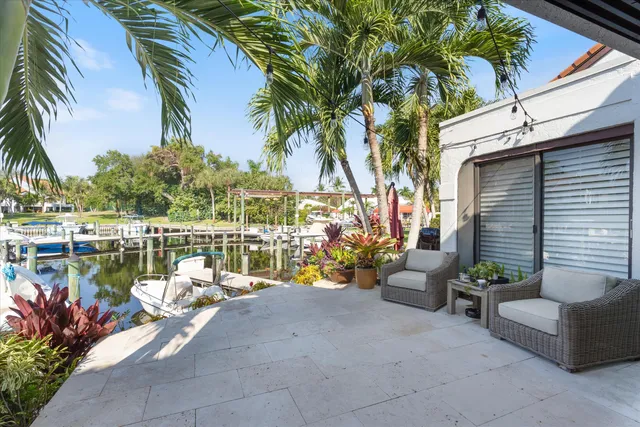 a view of a balcony with chairs and a potted plant