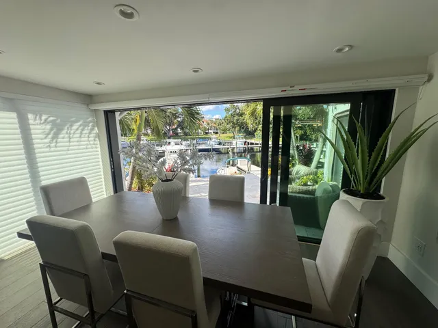 a view of a dining room with furniture large windows and wooden floor