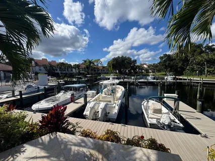 a view of a lake with couches chairs