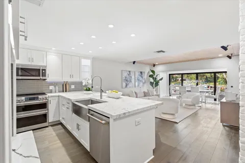 a kitchen that has a sink and a stove in it