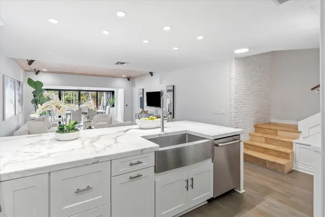 a kitchen with sink and white cabinets