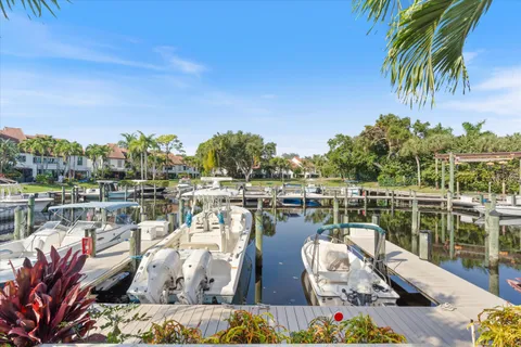a view of a lake with couches chairs