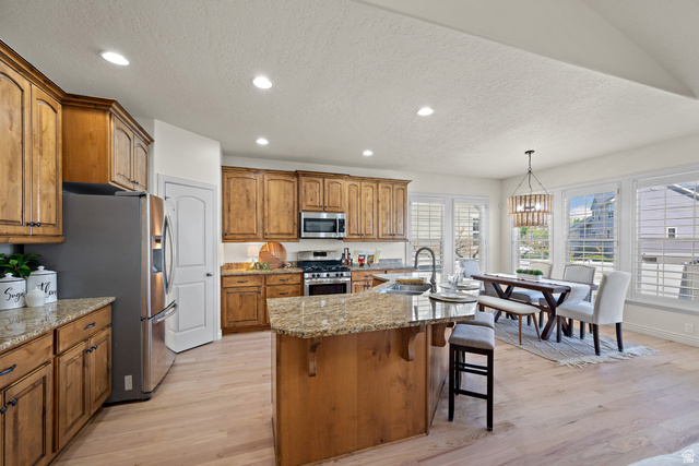 927 Iris Lane Mapleton, UT 84664 - Photo 11 of 31 Kitchen with wood-finish flooring, recessed lighting, and a center island featuring a granite countertop